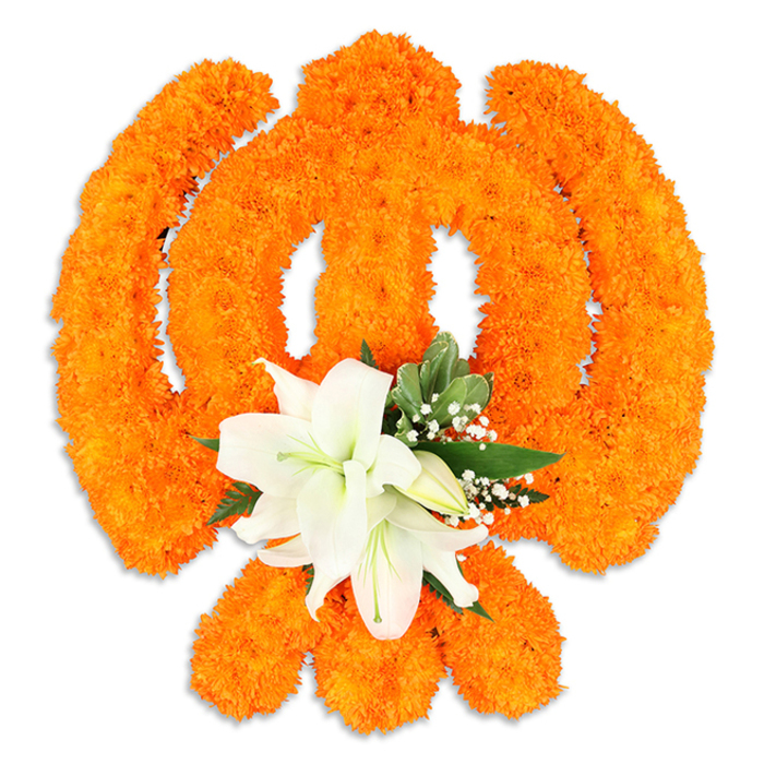 An elegant floral Ik Onkar rendered entirely in orange marigolds dominates a crisp white background, its revered contours- the vertical Ek, the subtle crescent-like strokes and the finishing dot-clearly traced in thousands of tiny, densely packed blooms. Each marigold head forms a soft, textured tile in the larger symbol, the collectively warm saffron hue glowing under gentle light and lending the piece a celebratory, devotional tone. At the lower center of the marigold composition a complementary cluster of pristine white lilies has been positioned: two or more fully open lilies with slightly unfurling petals, pale green throats and yellowish stamens, accompanied by small closed buds and delicate sprays of baby's breath. Bright, pointed green foliage tucks around the lilies and threads behind the marigolds, giving sculptural definition and a refreshing coolness against the dominant orange. A faint drop shadow beneath the arrangement suggests a three-dimensional, freestanding display-exactly the kind of floral emblem Flower Delivery Maidenhead might prepare for a community celebration, a Gurdwara offering, or a commemorative event near the Thames, Braywick Park or the town's High Street. The visual language here blends devotion and craftsmanship: the vigorous warmth of traditional marigolds balanced by the lilies' calm purity, producing a composition that speaks of unity, faith and careful local floral artistry in Maidenhead and neighbouring parishes.