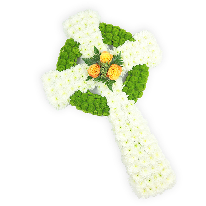 A striking floral Celtic cross, photographed against stark white so the sculpted form stands forward with three-dimensional clarity, composed of fresh, meticulously placed blooms. The arms and central shaft are densely faced with small white spray chrysanthemums, their clustered petals producing a soft, pillowy surface that reads as pure and consoling. Bright apple-green button chrysanthemums are set into the design to define the circular ring where the arms cross and to mark alternating panels along the horizontal bars; the chartreuse-green sections create an almost woven visual cadence and sharpen the cross's silhouette. Nestled at the centre, where the arms meet, is a delicate cluster of three orange to yellow-orange roses - compact, fully formed blooms whose warm tones create a poignant focal point against the cool white and vibrant green. Around the roses, a handful of dark green ferny sprigs give depth, contrast, and a faint evergreen scent that complements the sweeter rose notes. The soft, diffused studio lighting accentuates petal textures while keeping the overall mood respectful and serene. The palette of white, green, and orange subtly evokes Irish symbolism and is often chosen by families wishing to acknowledge Celtic heritage; locally in Maidenhead this arrangement is fitting for memorial services held near the River Thames or at community spaces like Norden Farm, where reverence and local tradition meet. As a florist I describe it as a composition of quiet strength - a tactile, memorable tribute intended to convey condolences, faith, and enduring remembrance.